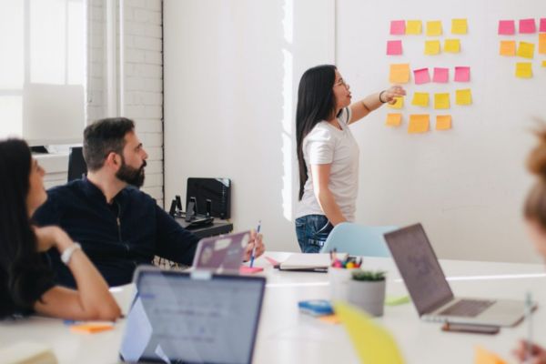 Woman in a brainstorming meeting with coworkers.