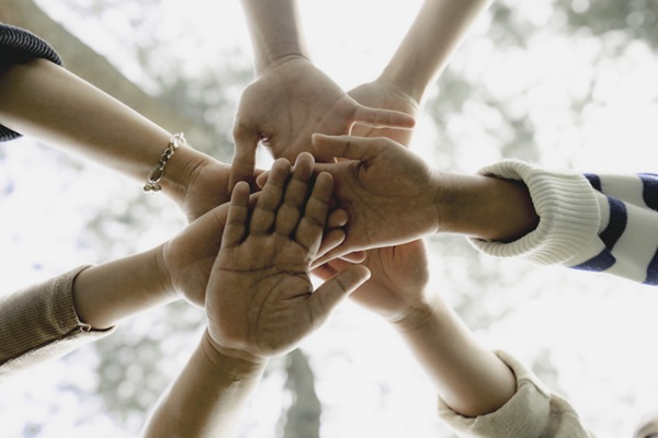 Low angle view of a diverse group of people shaking hands