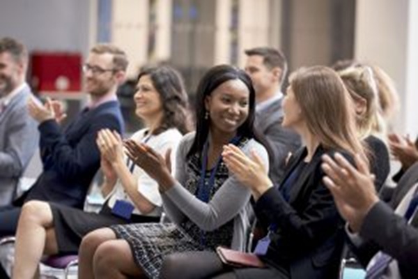 People at a conference clapping