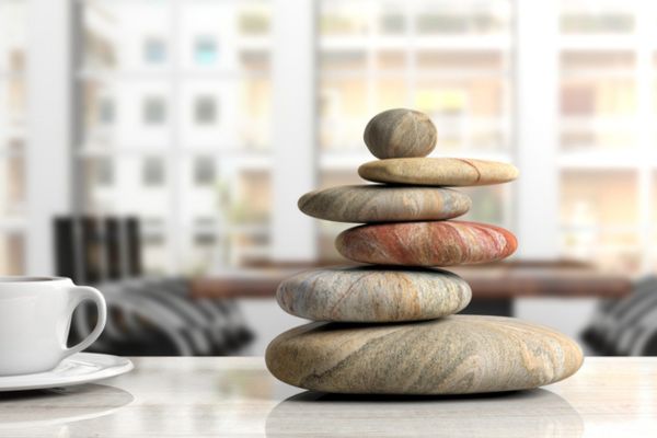 Relaxation at the office. Zen stones stack on an office desk.