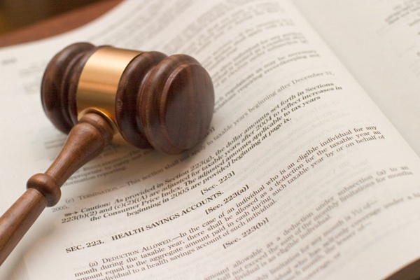 Gavel resting on a chapter of a law book