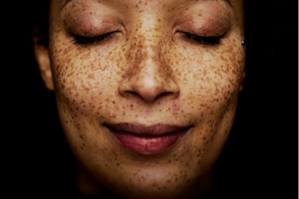 Close up of a freckled woman's face.