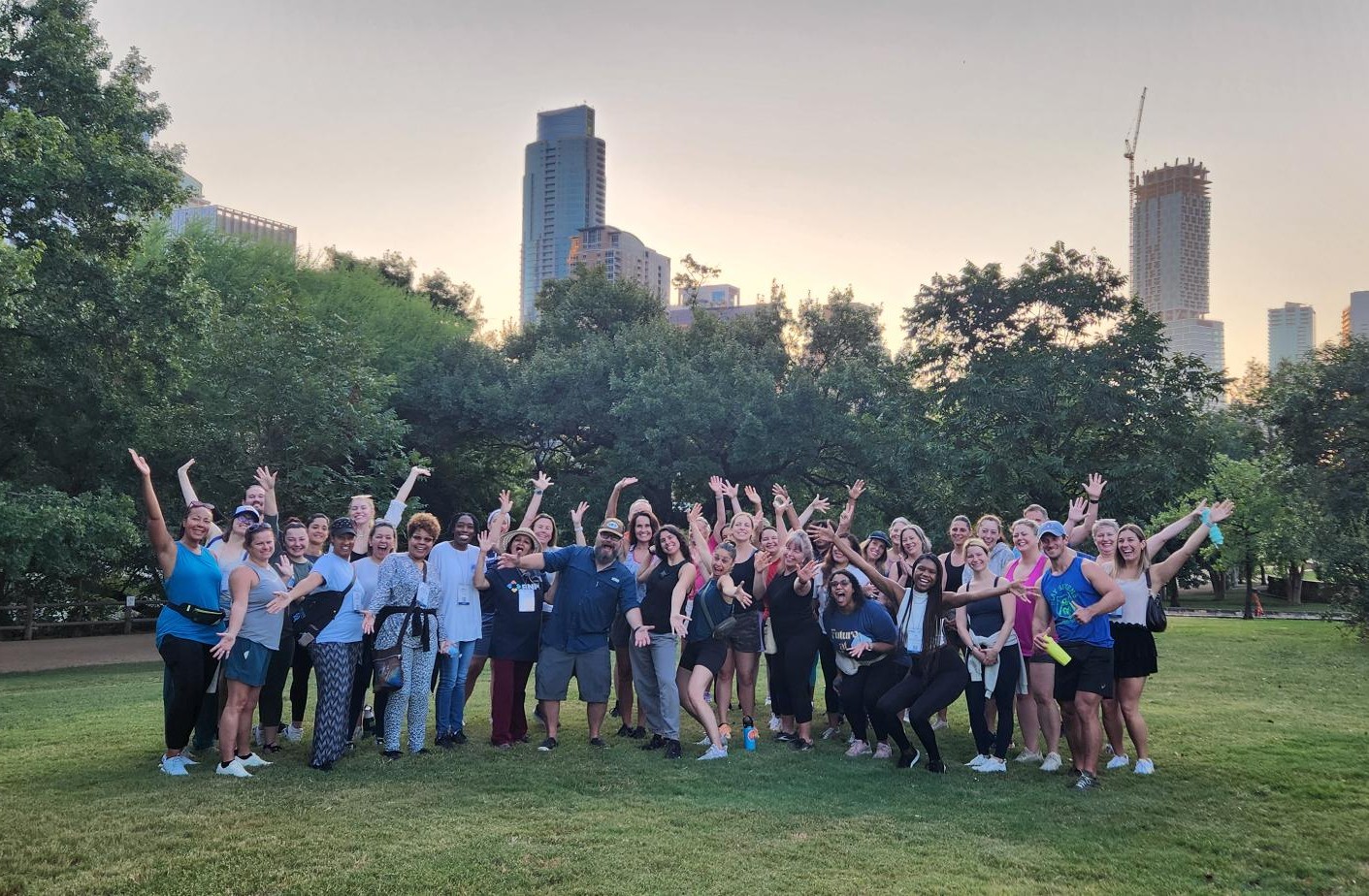 A group of Annual Wellness Summit attendees taking a nature walk in Barton Springs, TX.