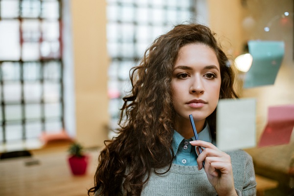 Concentrated woman making plan on sticky notes