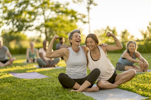 Strong women smiling during an outdoor fitness group event