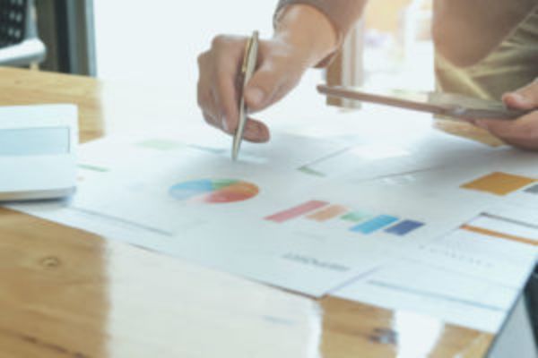 A person writing on graphs