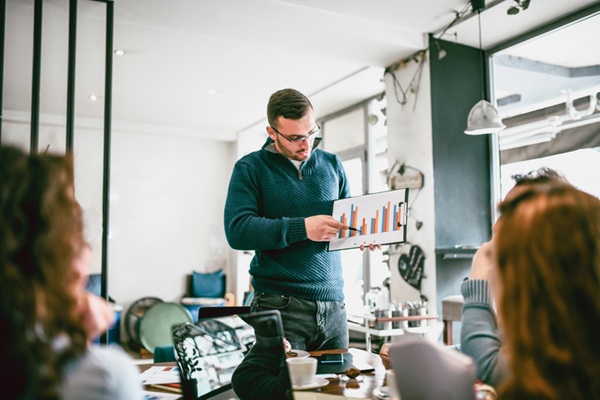 Business Colleagues Present Statistics While Having Team Building