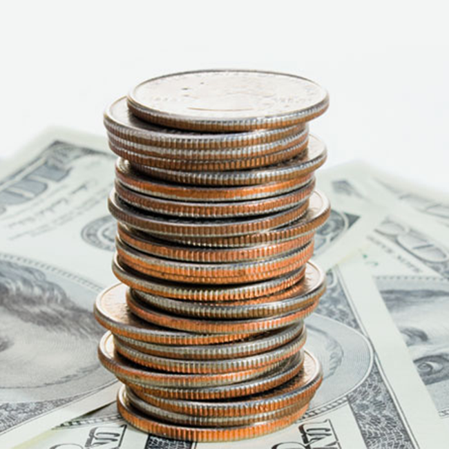 A stack of pennies on hundred dollar bills