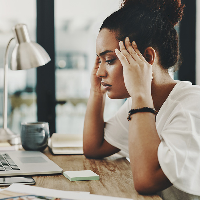 Stressed woman looking at laptop